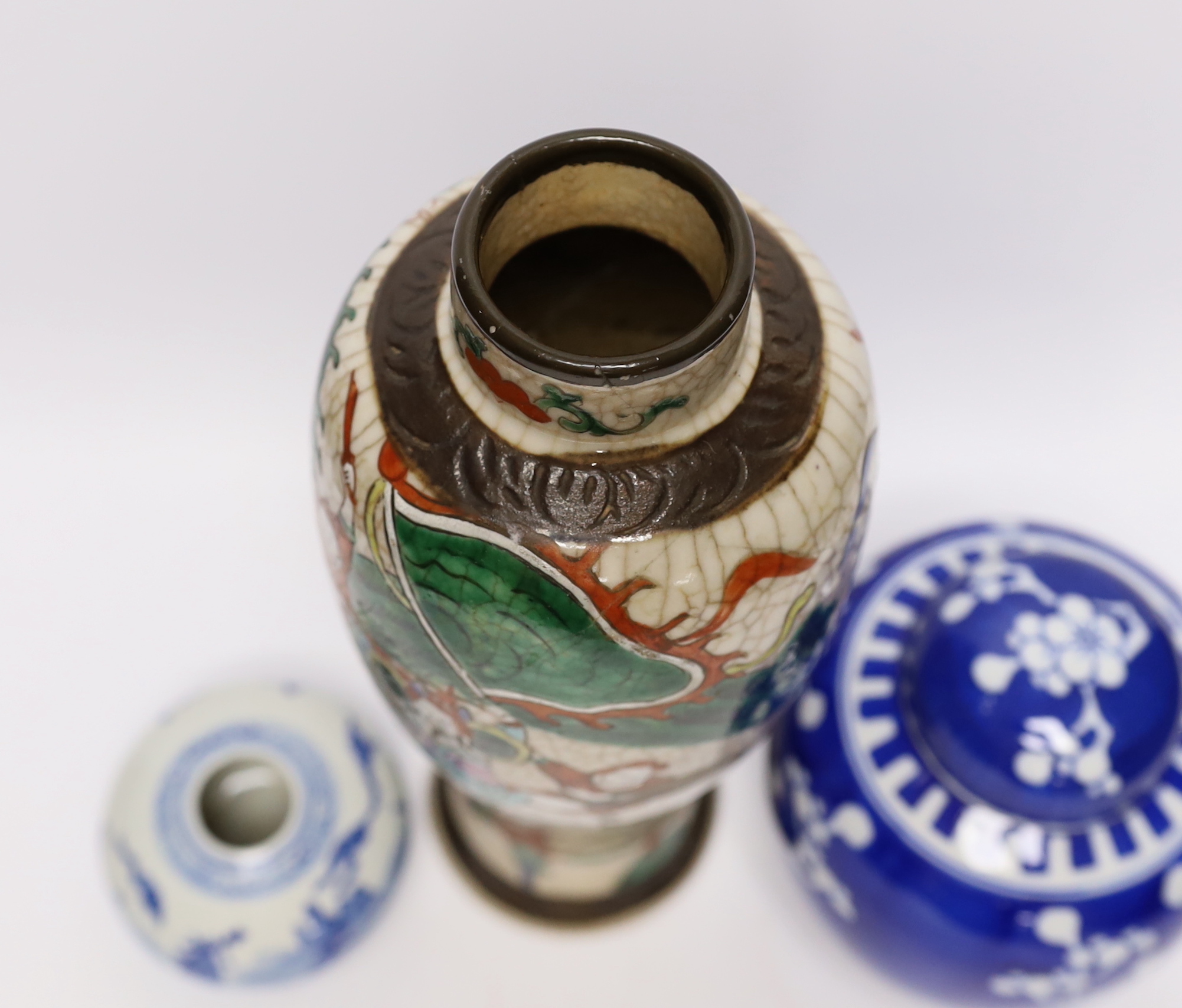 An early 20th century Chinese crackle glaze vase and two blue and white jars, largest 30cm high